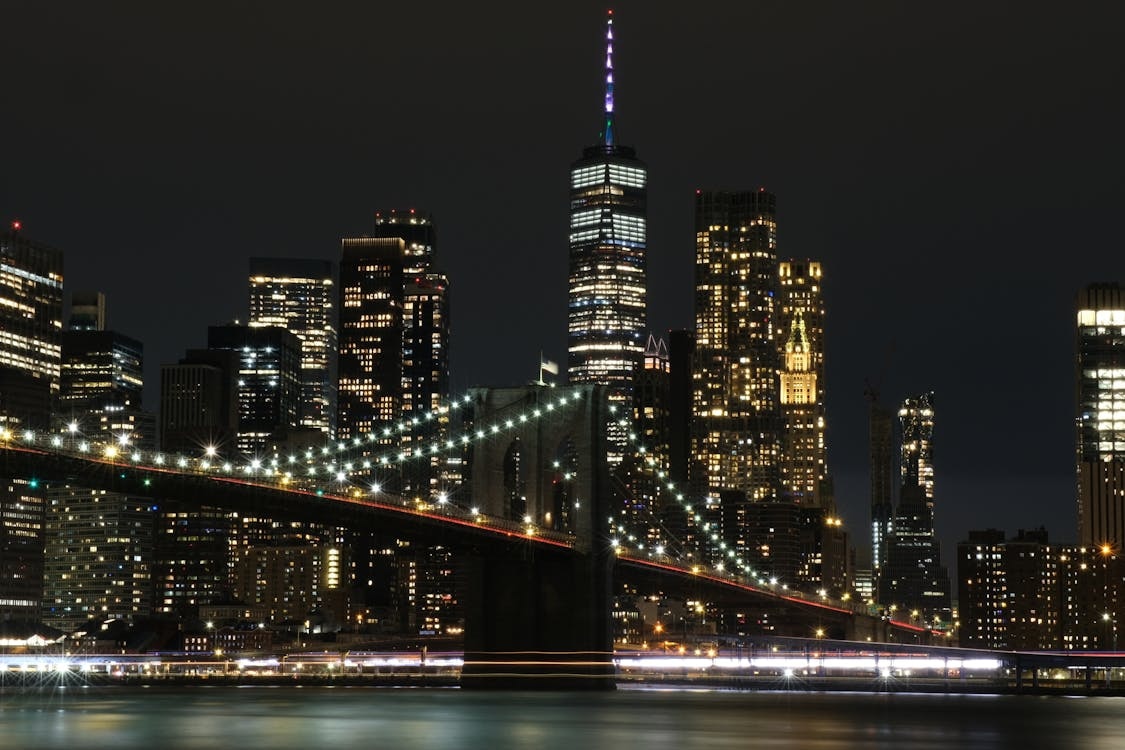 The Manhattan skyline and Brooklyn Bridge lit up at night